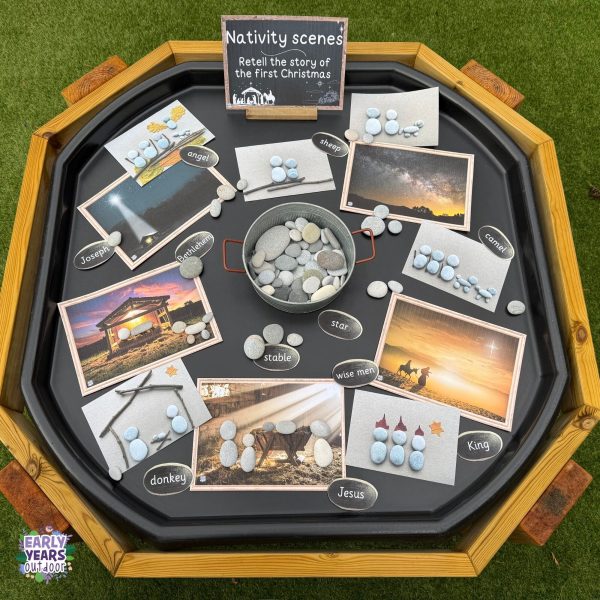 Nativity images and nativity pebbles resource set out in a tuff tray with bowls of pebbles and key words