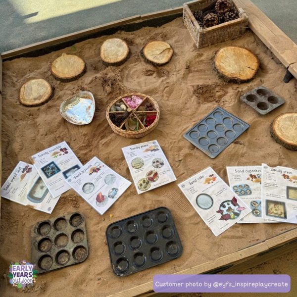 Sand mud kitchen recipes in sand box, with log slices, muffin trays and nature