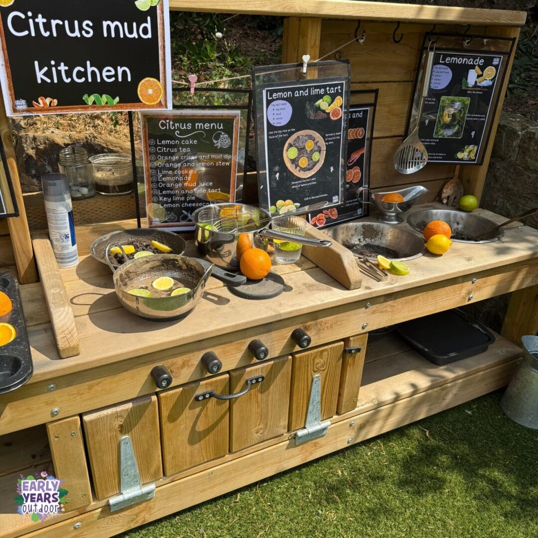 Citrus mud kitchen Citrus themed mud kitchen set up with recipes, a menu, wooden and plastic citrus fruits, mud, pans, bowls and utensils