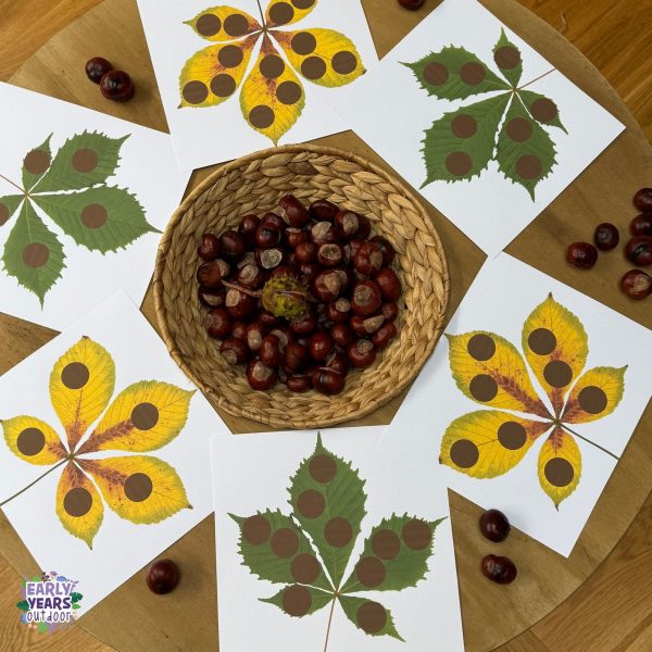 Conker matching activity set up with the spotty leaf sheets and a basket full of conkers in the middle