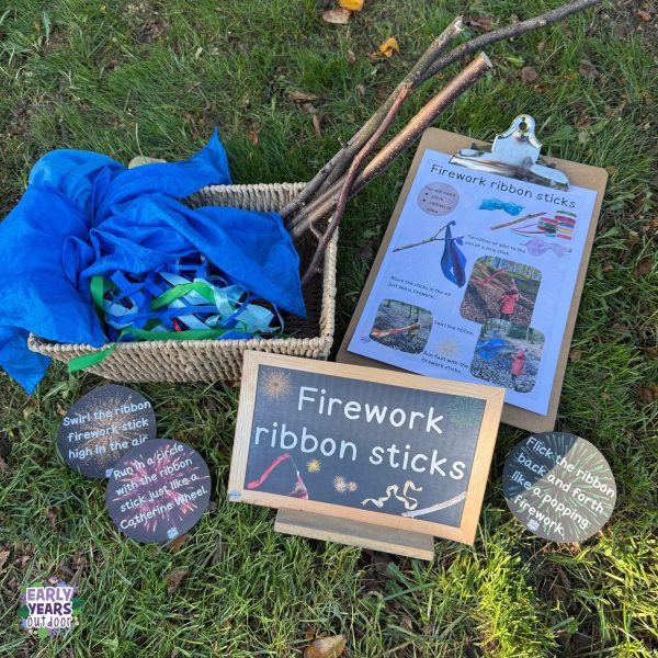 Firework ribbon stick activity set up with activity sheet, basket of ribbon and material, sign and firework labels
