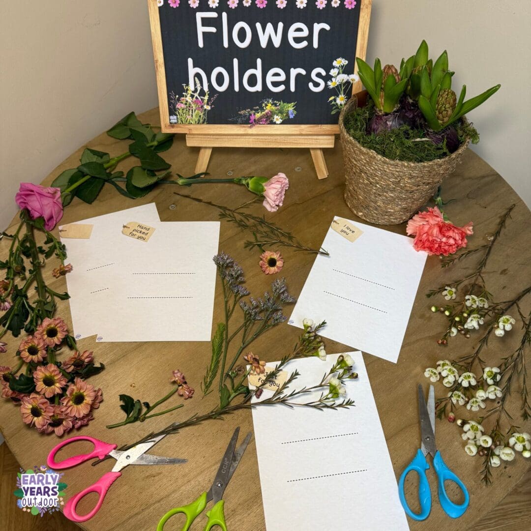 Flower holders Flower holder activity set up with sign, scissors, flowers, nature and the holder sheet