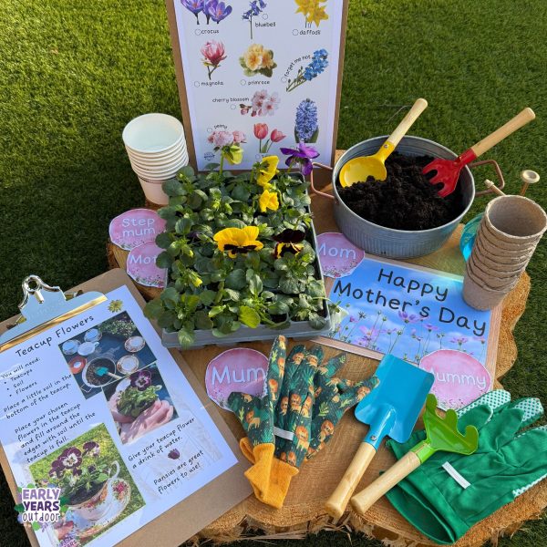 Mother's Day signs set up with a tray of pansies, a trowel, gardening gloves, a bowl of soil, paper cups, Spring flowers ID sheet and teacup flowers instruction sheet